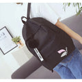 Green canvas college style schoolbag with leaves pattern and anti-theft features