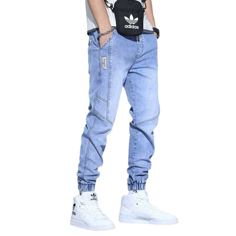 Men's slim fit straight-leg jeans in blue denim with high waist and ankle-tied style