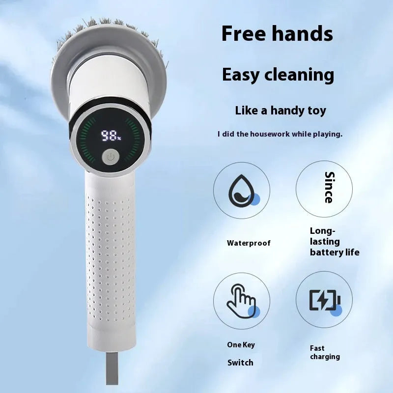 White cordless electric cleaning brush with interchangeable heads on a kitchen counter.