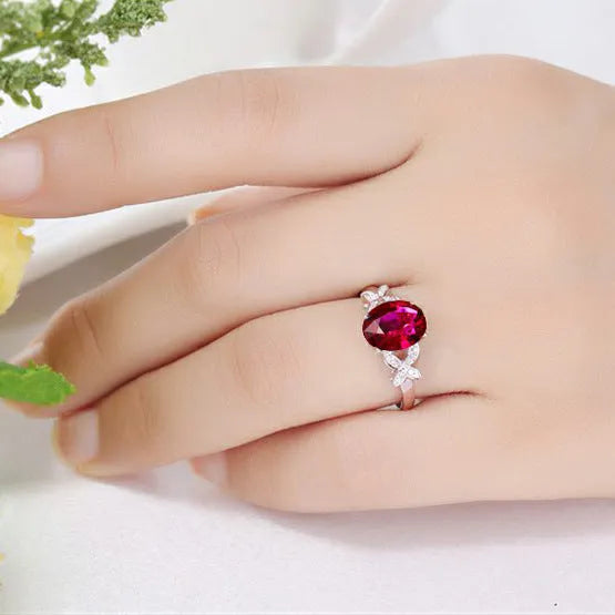 Close-up of a women's rose gold plated butterfly ring shaped like a heart with coloured enamel details.