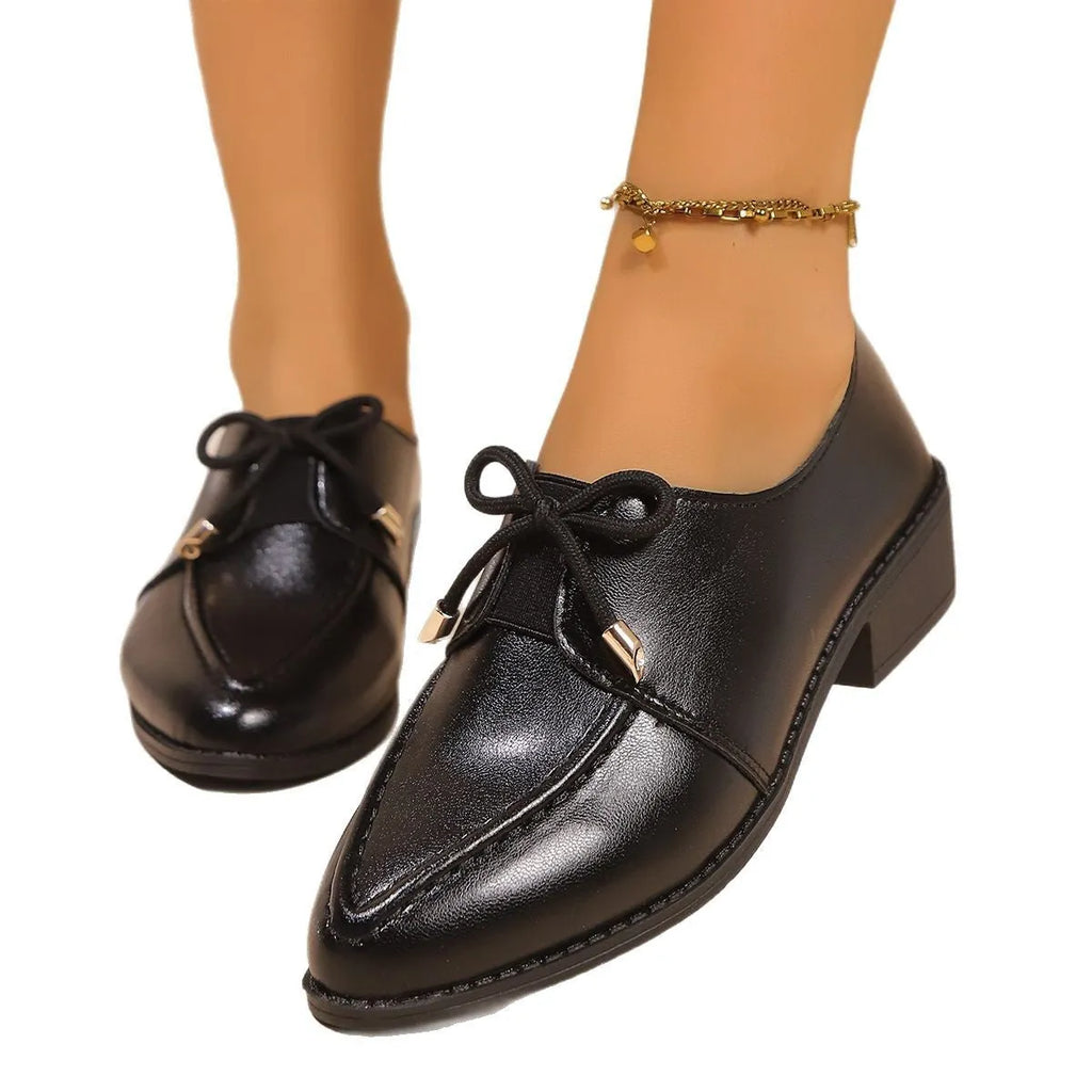 Women's British-style loafers with a bow detail on a PU upper and rubber sole.