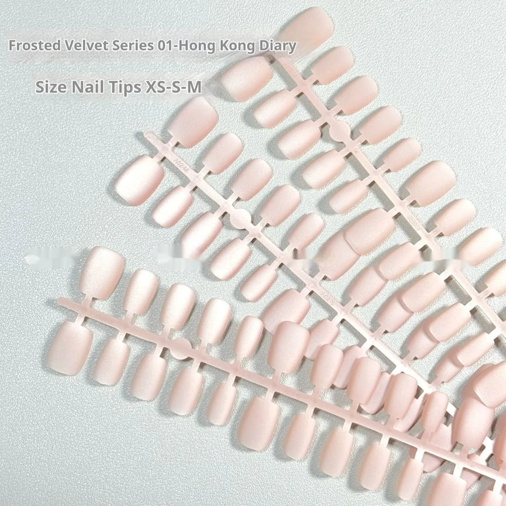 Set of frosted velvet cat's eye false nails with aurora armour design in short ladder sizes on a clear background.