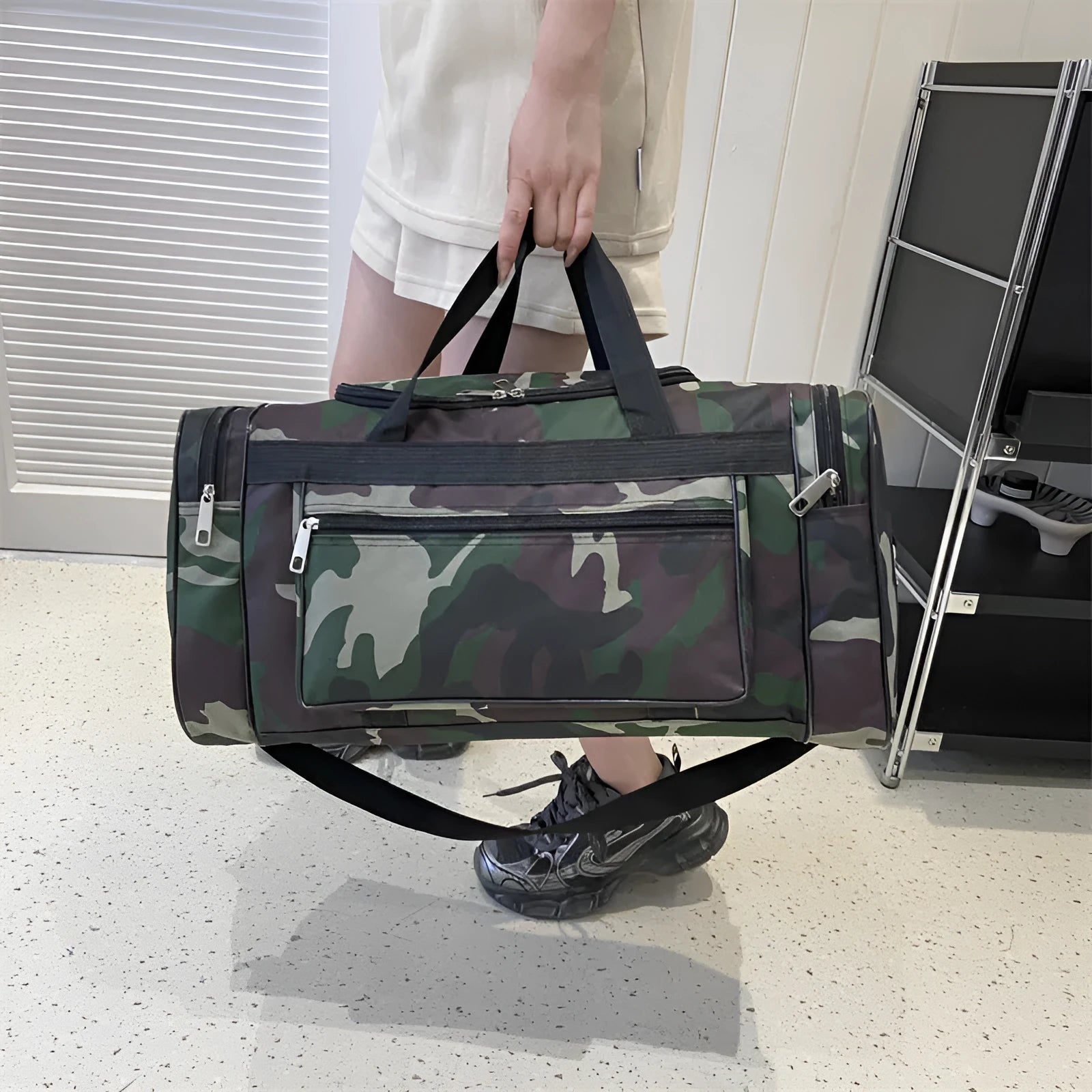 Large camouflage coloured waterproof luggage bag with striped polyester lining.