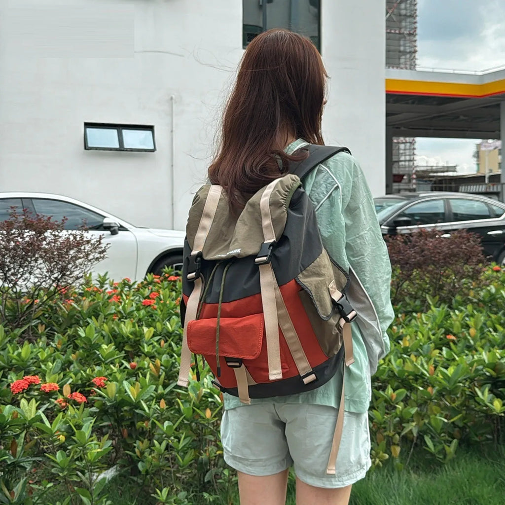 Orange green contrast colour outdoor backpack with multiple compartments and air pillow belt system