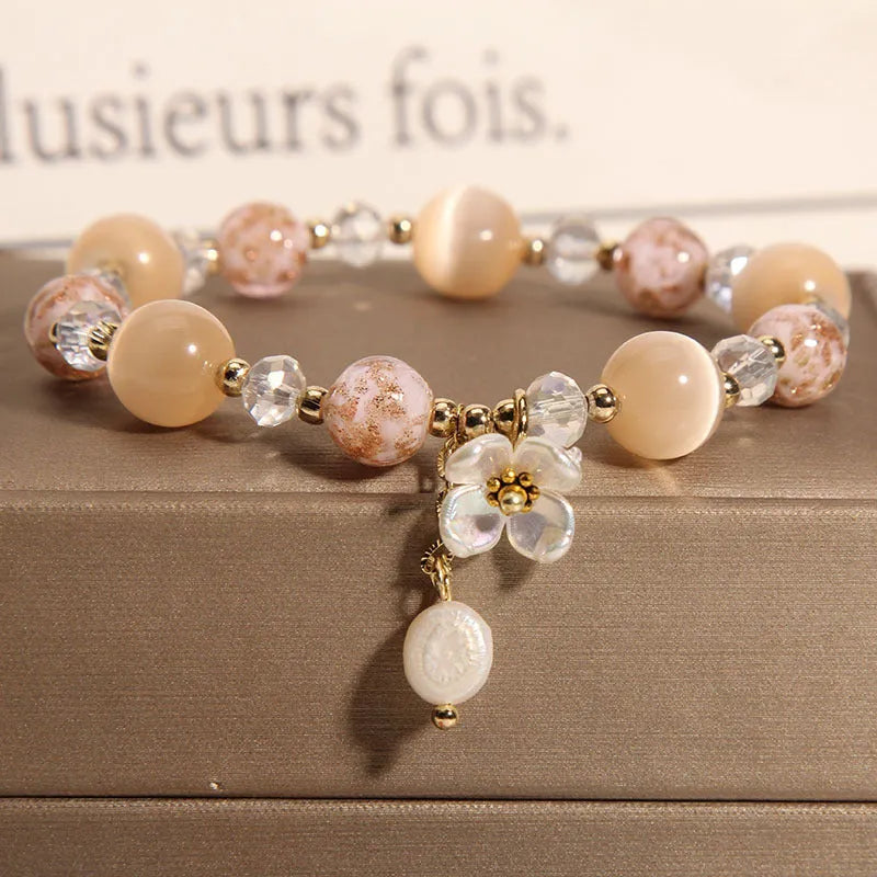 Woven aquamarine crystal bracelet with opal floral elements and cat motifs