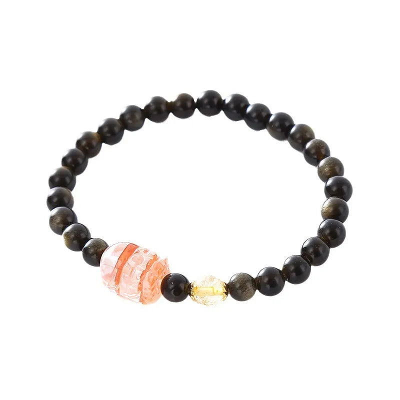 Handmade black obsidian and gold Pi Xiu charm bracelet with red flowers.