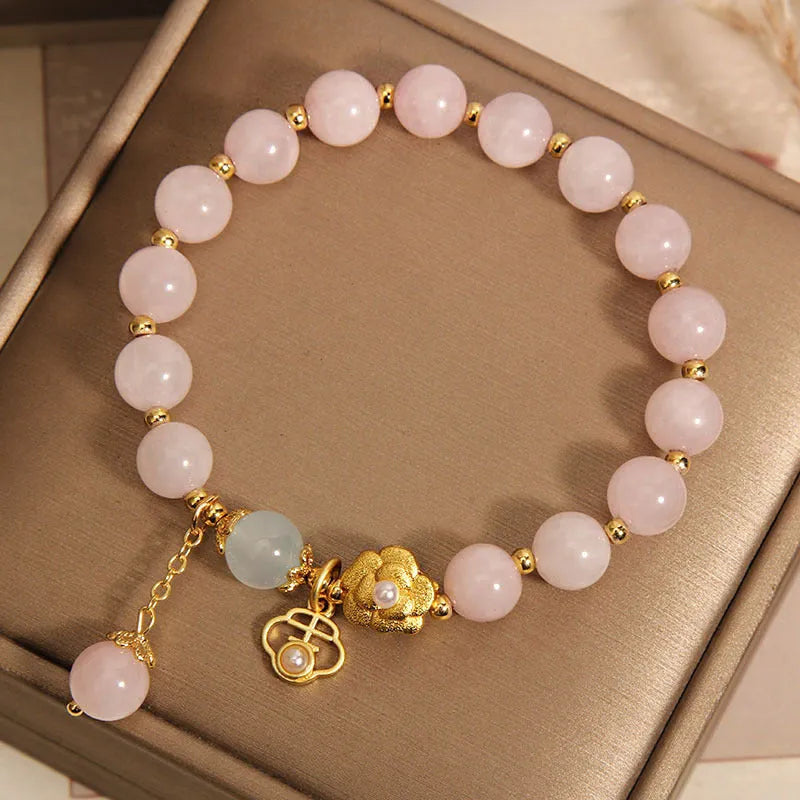 Women's pink crystal flower charm bracelet with delicate floral design