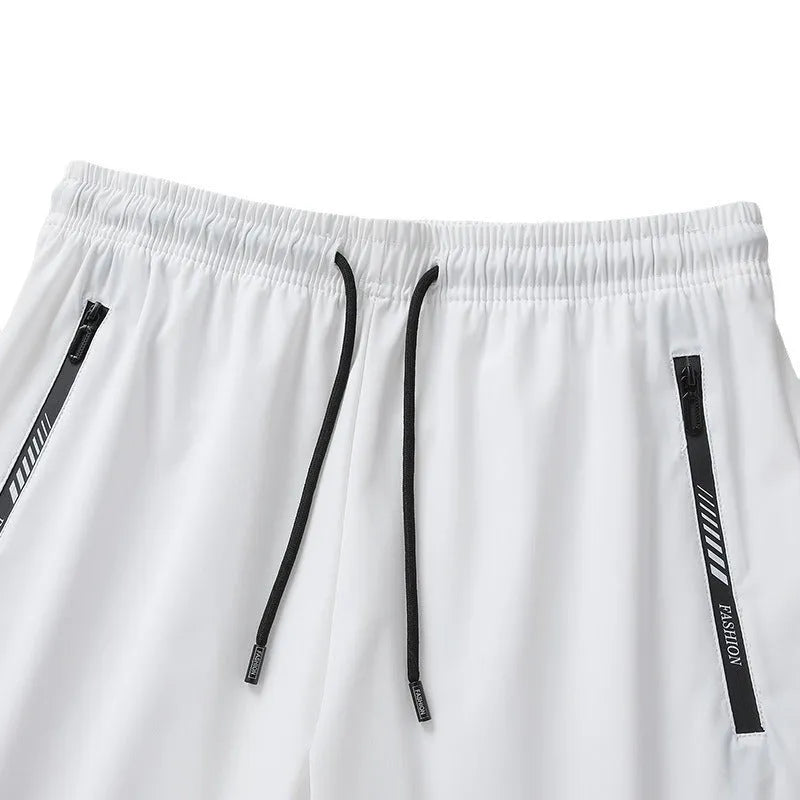 Man wearing black quick-dry nylon sports shorts with a loose fit and elastic waistband.