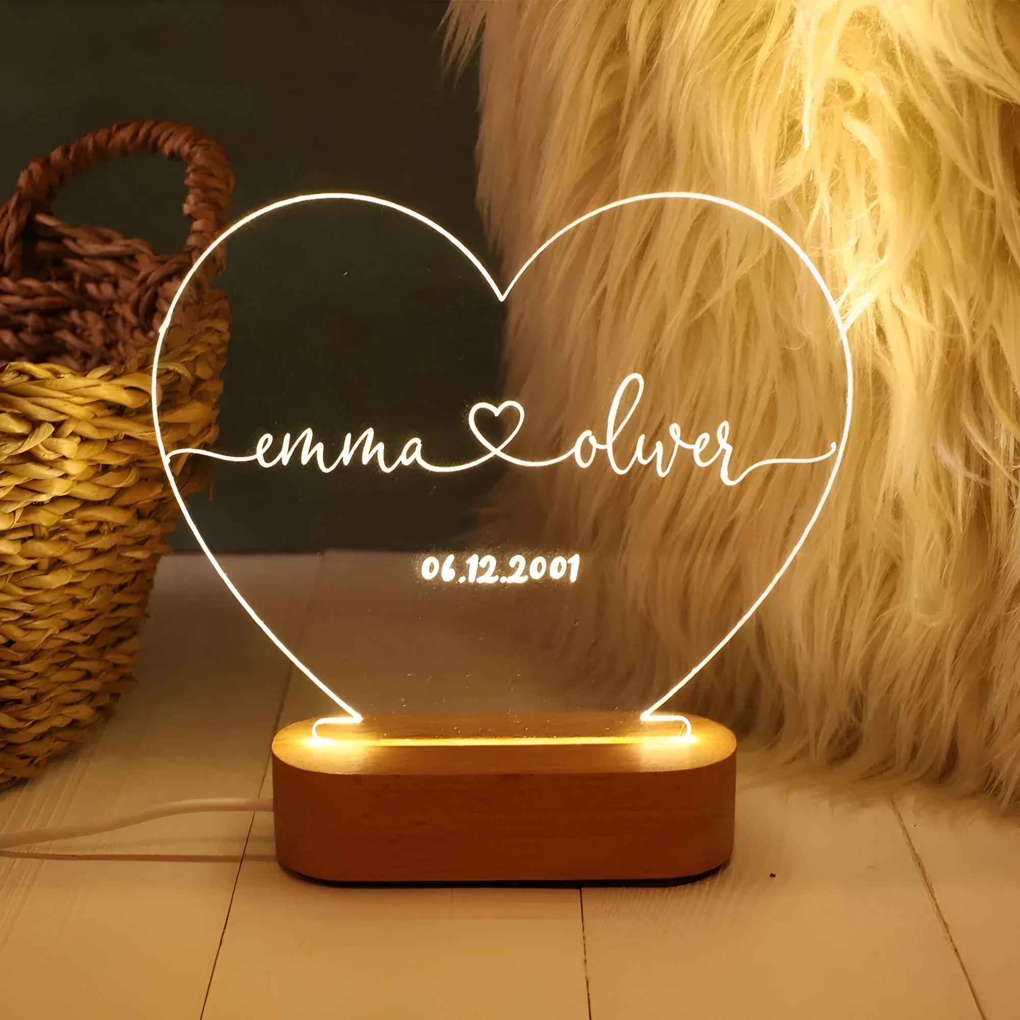 Custom engraved acrylic night light with names and date, illuminated by an LED base.