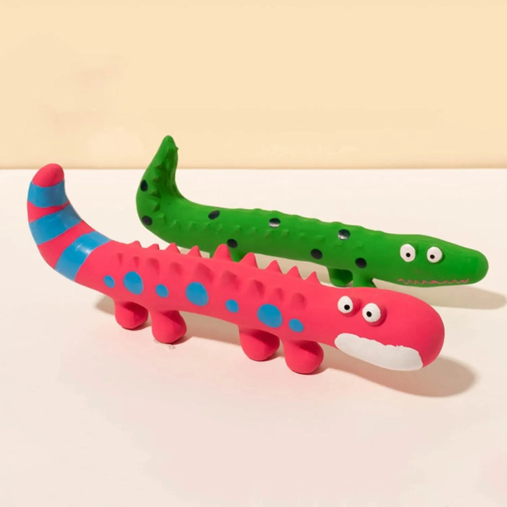Green cartoon lizard-shaped dog chew toy with a squeaker on a white background.