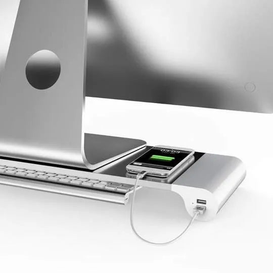 Smart aluminium and plastic computer monitor stand with USB charging ports and a hidden keyboard storage shelf