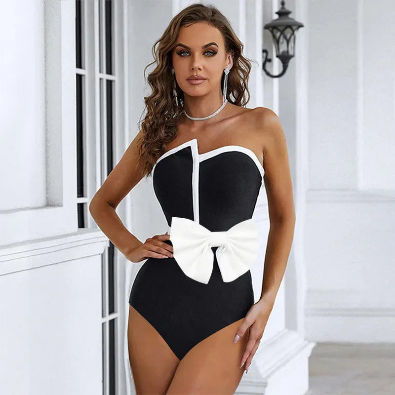 Women's black and white colour-block one-piece swimsuit with asymmetrical bow detail and tube top design