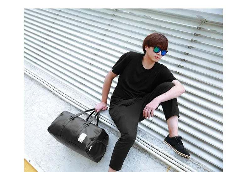 Black unisex waterproof sports bag with a separate shoe compartment and diagonal straps.