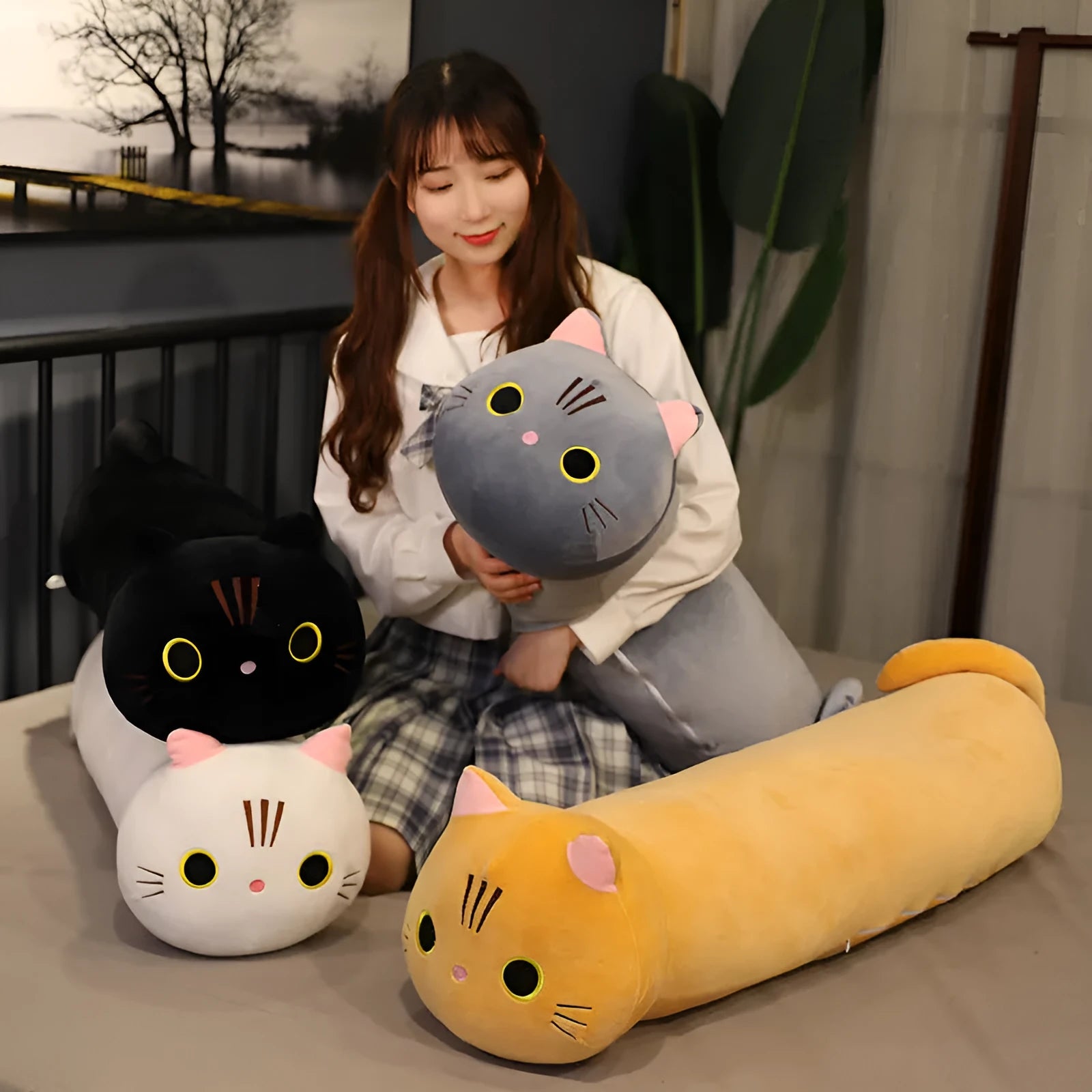 Large grey cat plush toy pillow on a sofa showing its soft texture and size.