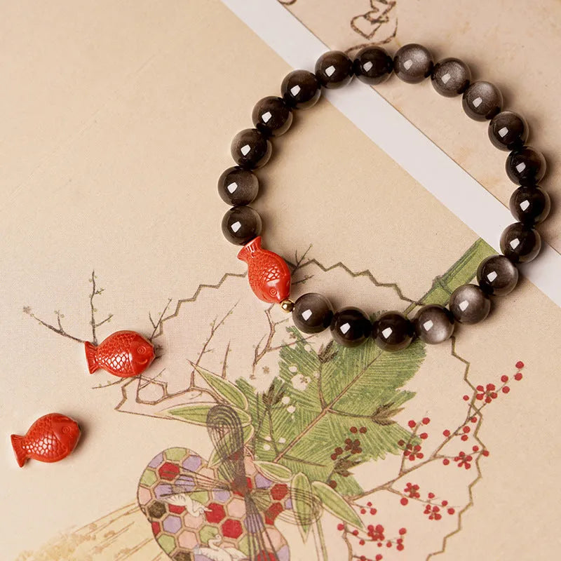 Natural obsidian bracelet with cinnabar fungal growth in round beads, showing stone patterns