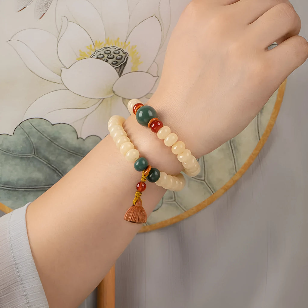 Women's cream topaz Bodhi wooden bracelet with flat round beads on a 15-20cm wrist.