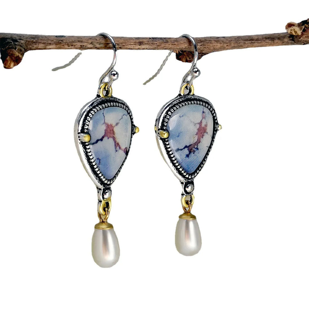 Retro blue bohemian drop earrings with synthetic opal and white pearl on metal.