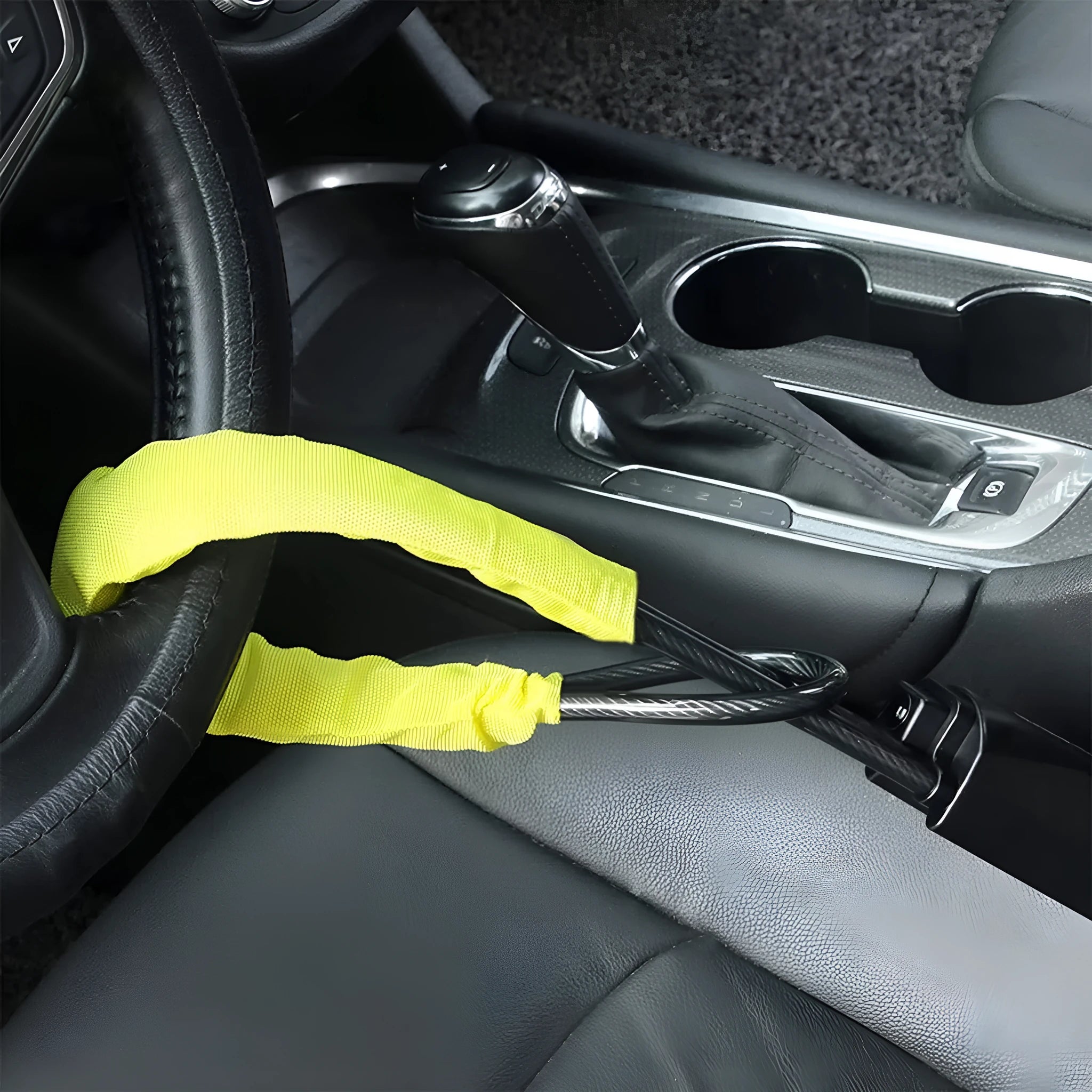 Red iron car steering wheel lock with brass core for General Motors vehicles on a steering wheel.