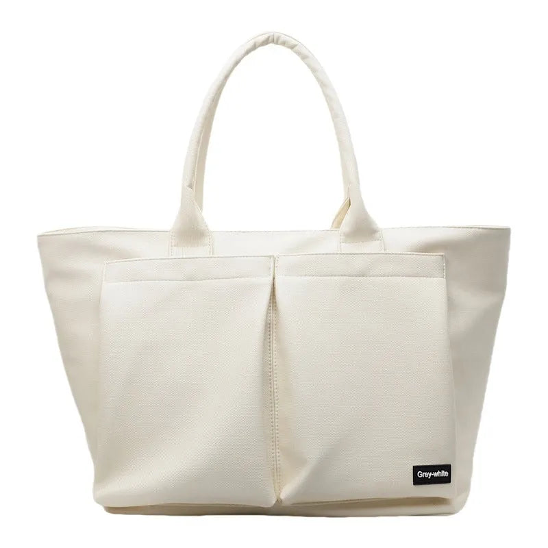 Lightweight expandable shoulder bag in solid colour with ventilation feature