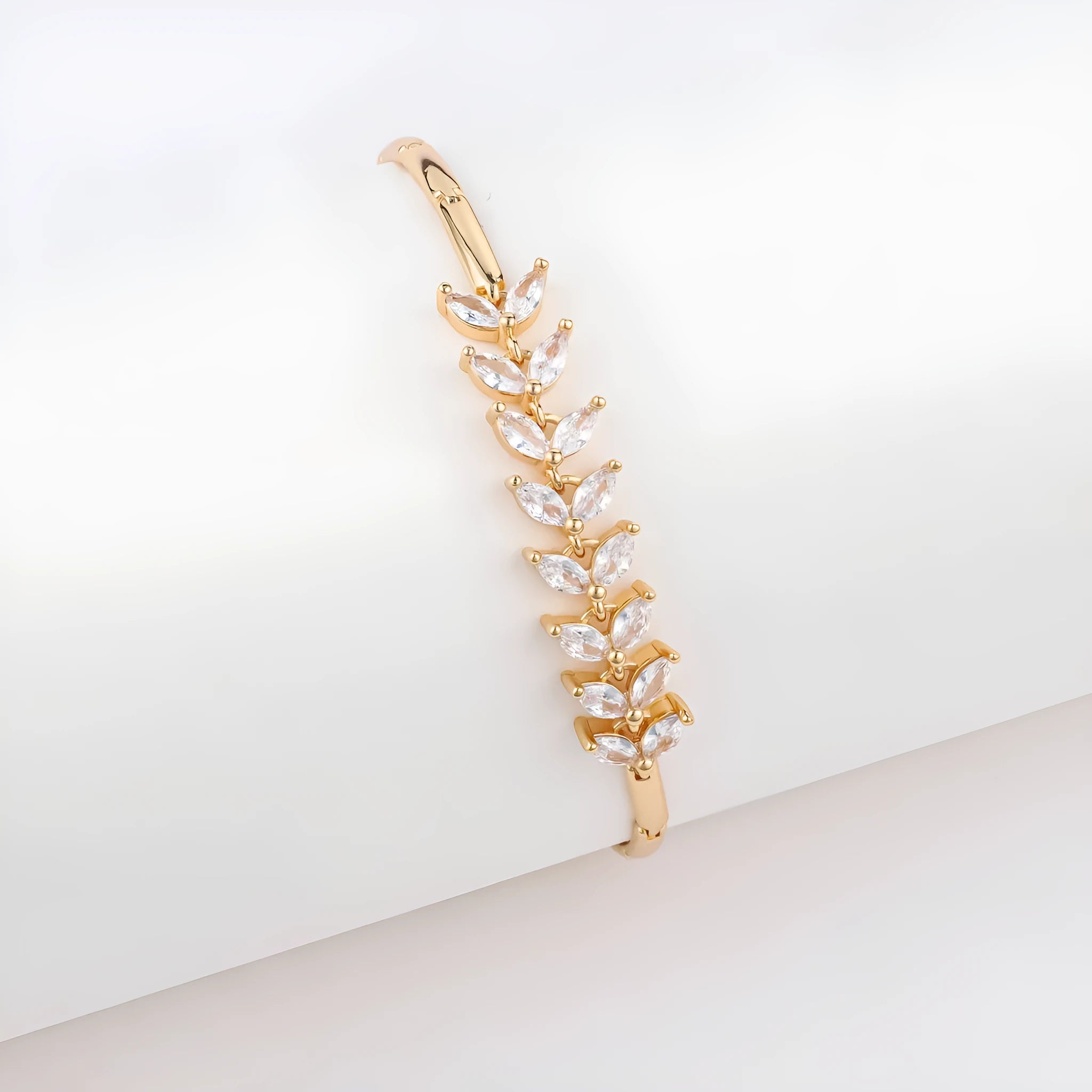 18K gold-plated butterfly clover brass bracelet with zircon stone on plain background