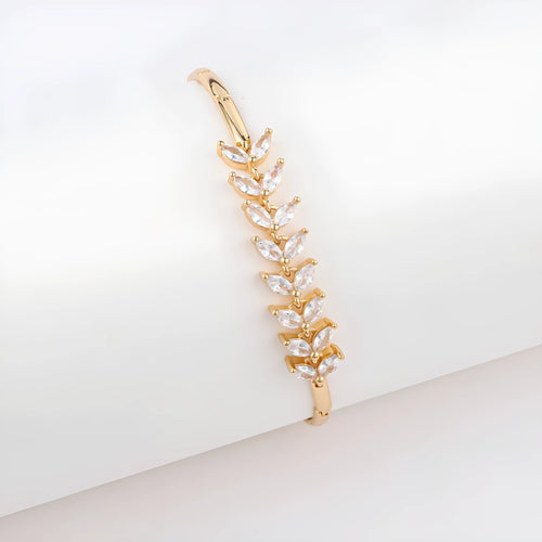 18K gold-plated butterfly clover brass bracelet with zircon stone on plain background
