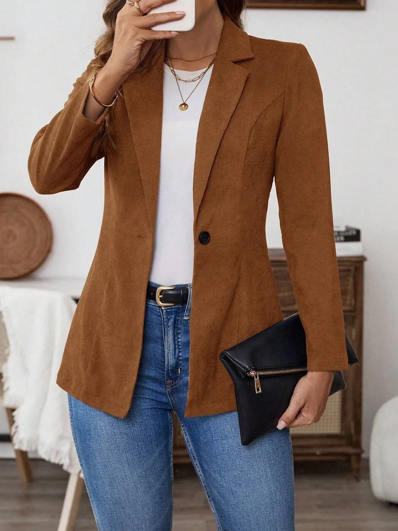 Brown men's single-breasted blazer with lapel collar and long sleeves on a hanger.