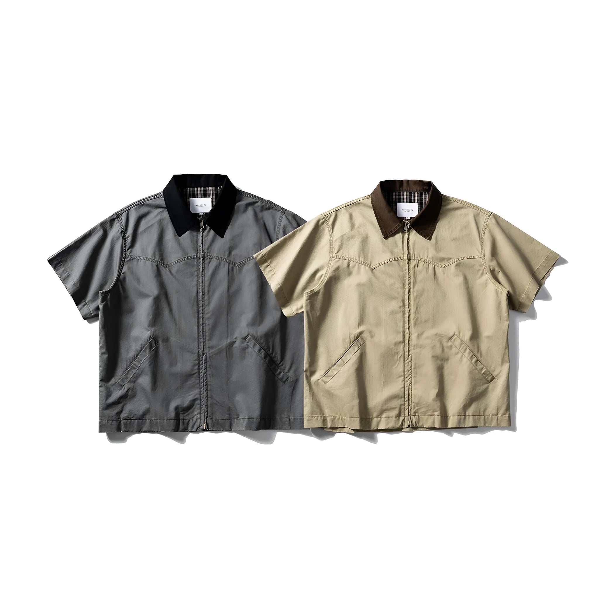 Washed grey cotton overalls shirt with short sleeves and a loose cardigan style on a hanger.