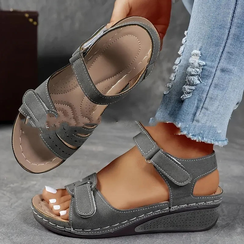 Women's beige thick-bottom strap sandals showing the Velcro fastener and round toe design.