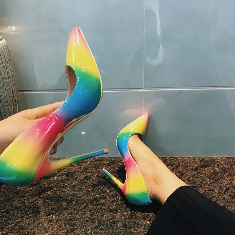 Rainbow patent leather women's high heel shoes with pointed toe and thin stiletto heel.