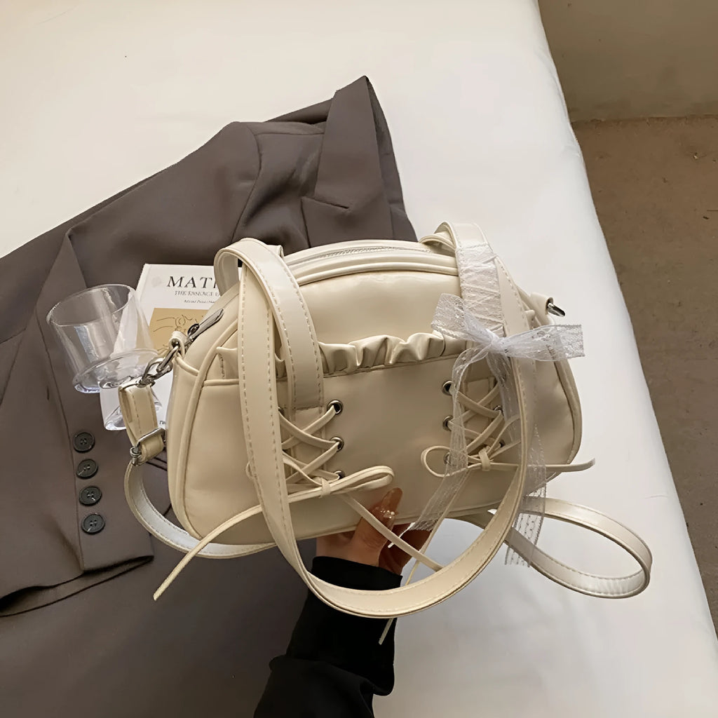 Women's casual PU leather shoulder bag with a bandage bow design and internal phone compartment.