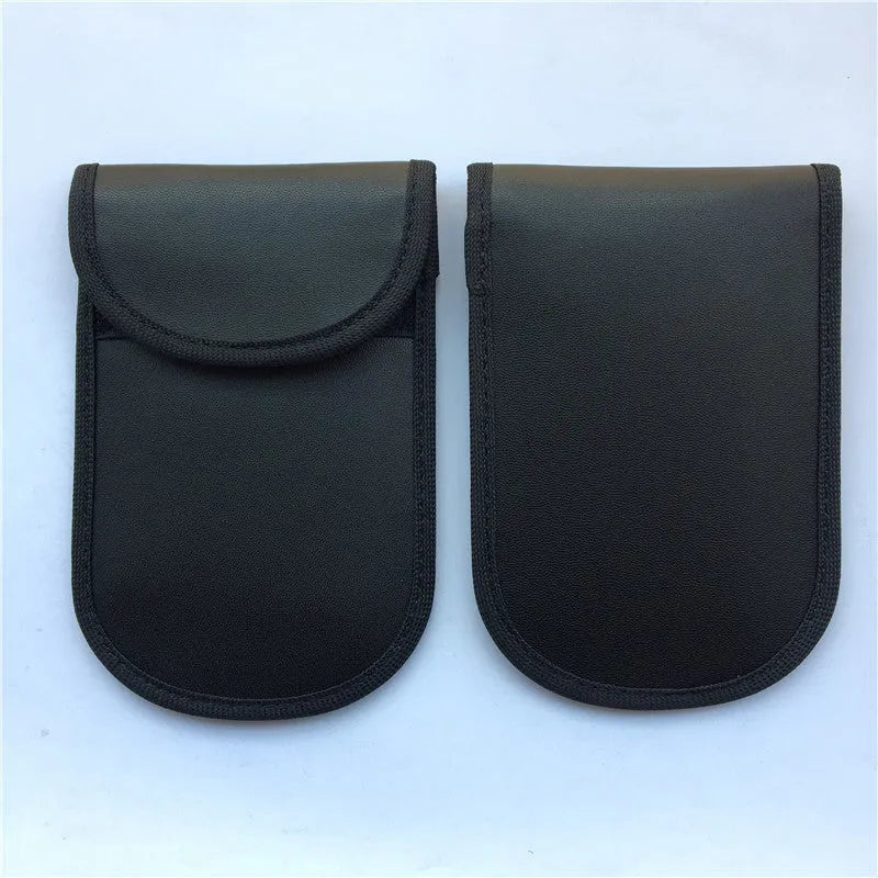 Black signal-blocking Faraday pouch for car key fobs, size 20x10 cm, lying flat on a surface