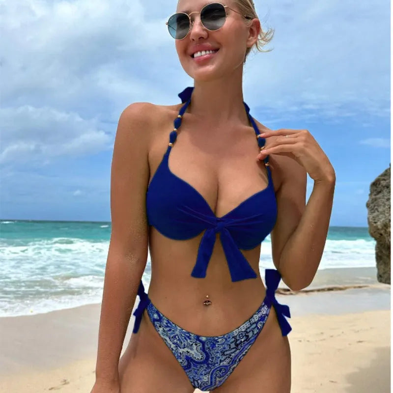 Ladies polyester bikini swimsuit set on a white background, showing top and pants in a blue colour.