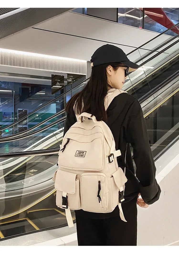Black or white nylon student backpack with computer compartment and three-dimensional pockets