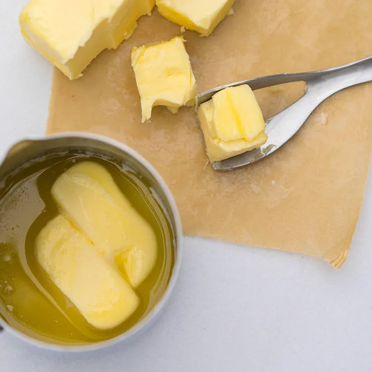 Stainless steel butter cutter with 12cm blade and sharp edge on a surface