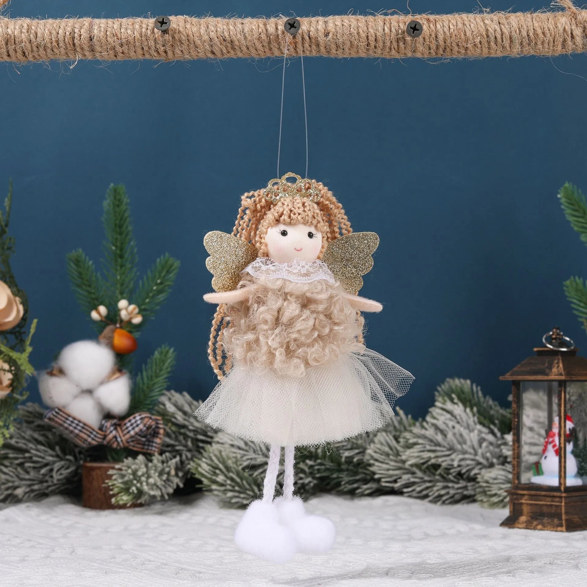 Cartoon angel cloth hair pendant on a girl's high ponytail in white, pink, and khaki colours.