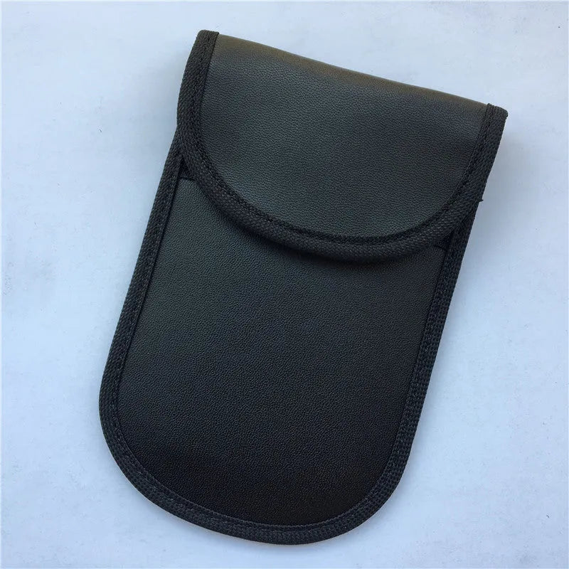 Black signal-blocking Faraday pouch for car key fobs, size 20x10 cm, lying flat on a surface