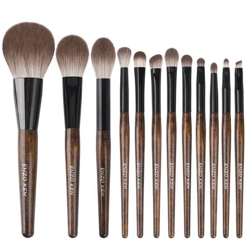 12-piece makeup brush set with wooden handles and a black PU travel case open to show brushes.