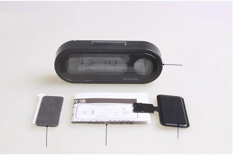 Black electronic car clock and thermometer with LED digital display on an adjustable dashboard bracket.