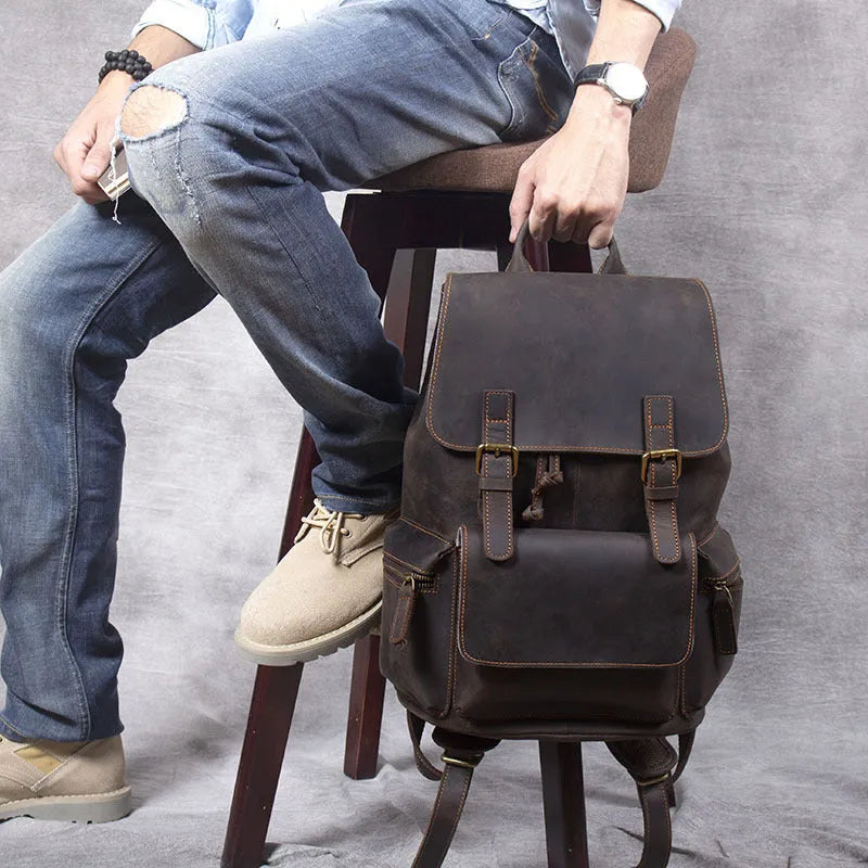 Brown crazy horse leather backpack with denim lining and double shoulder straps.