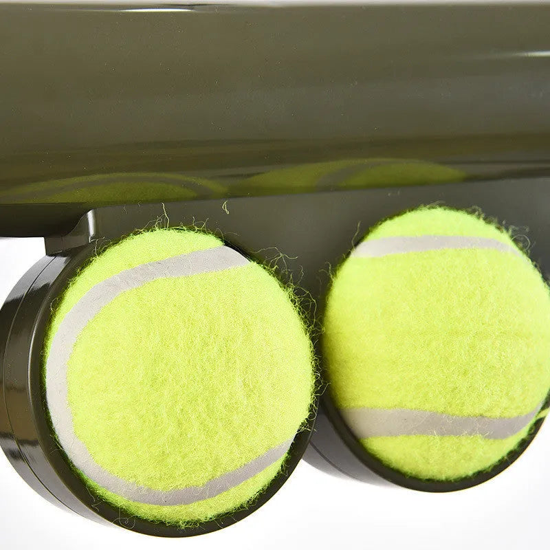 Black ABS plastic tennis ball launcher for dogs with two included tennis balls