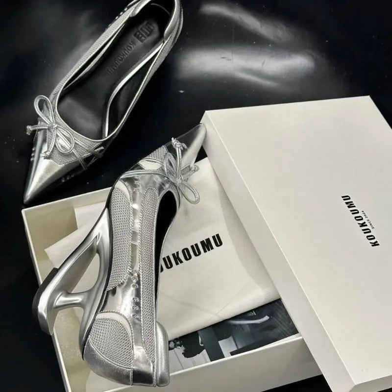 Black women's pointed toe Mary Jane shoes with a floating heel and slip-on design.