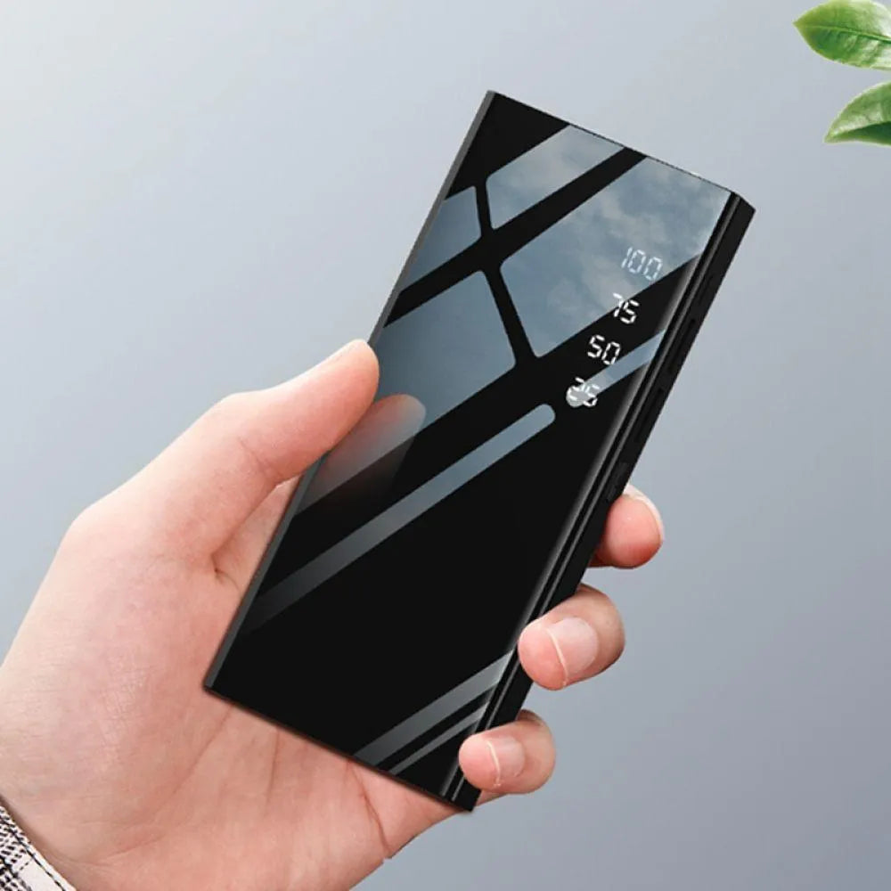 Black 20000mAh power bank showing LCD screen and two USB ports.