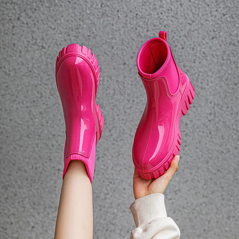 Women's creamy-white PVC low tube rain boots with flat heel and non-slip sole.