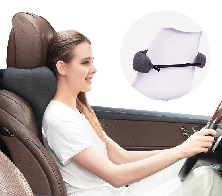 Solid-colour car neck memory pillow in dark grey, shown on a car headrest.