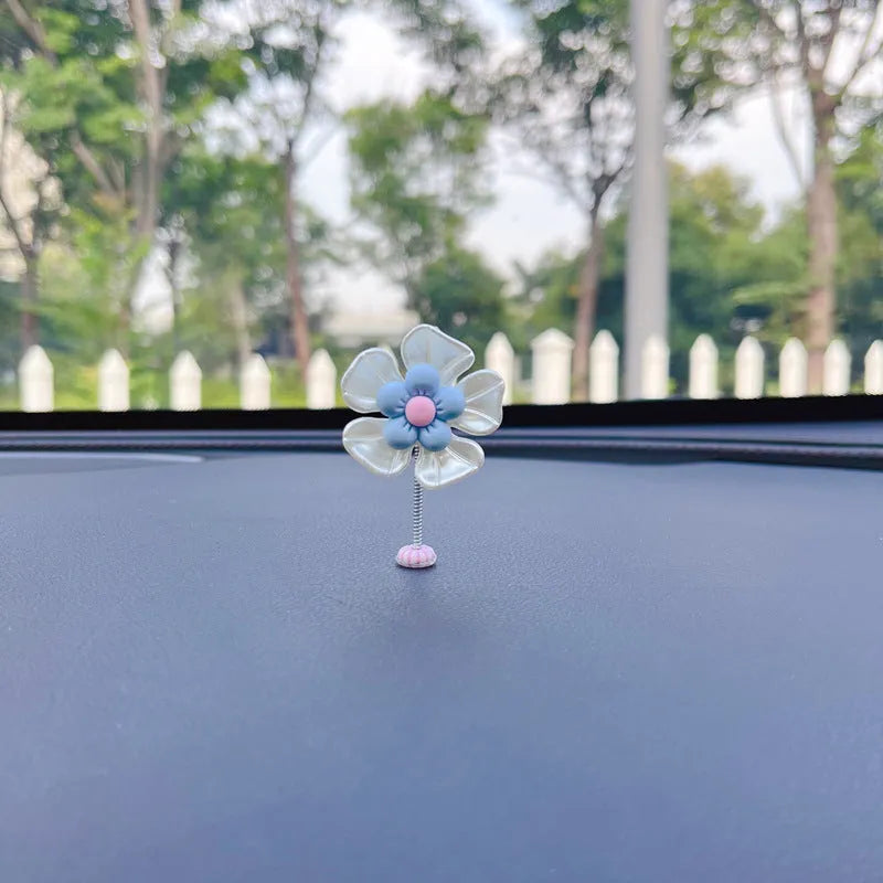 Small blue plastic swing ornament for car rear-view mirror, approx. 5cm tall.