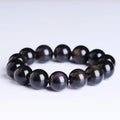 Polished crystal Pi Xiu bracelet with geometric beads on wrist, showing ice stone colour.