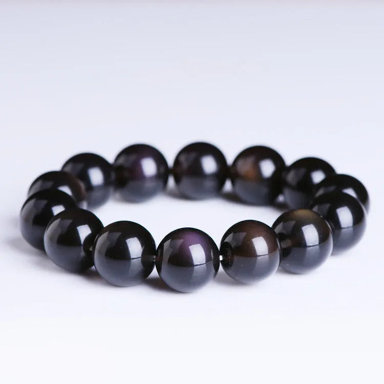 Polished crystal Pi Xiu bracelet with geometric beads on wrist, showing ice stone colour.