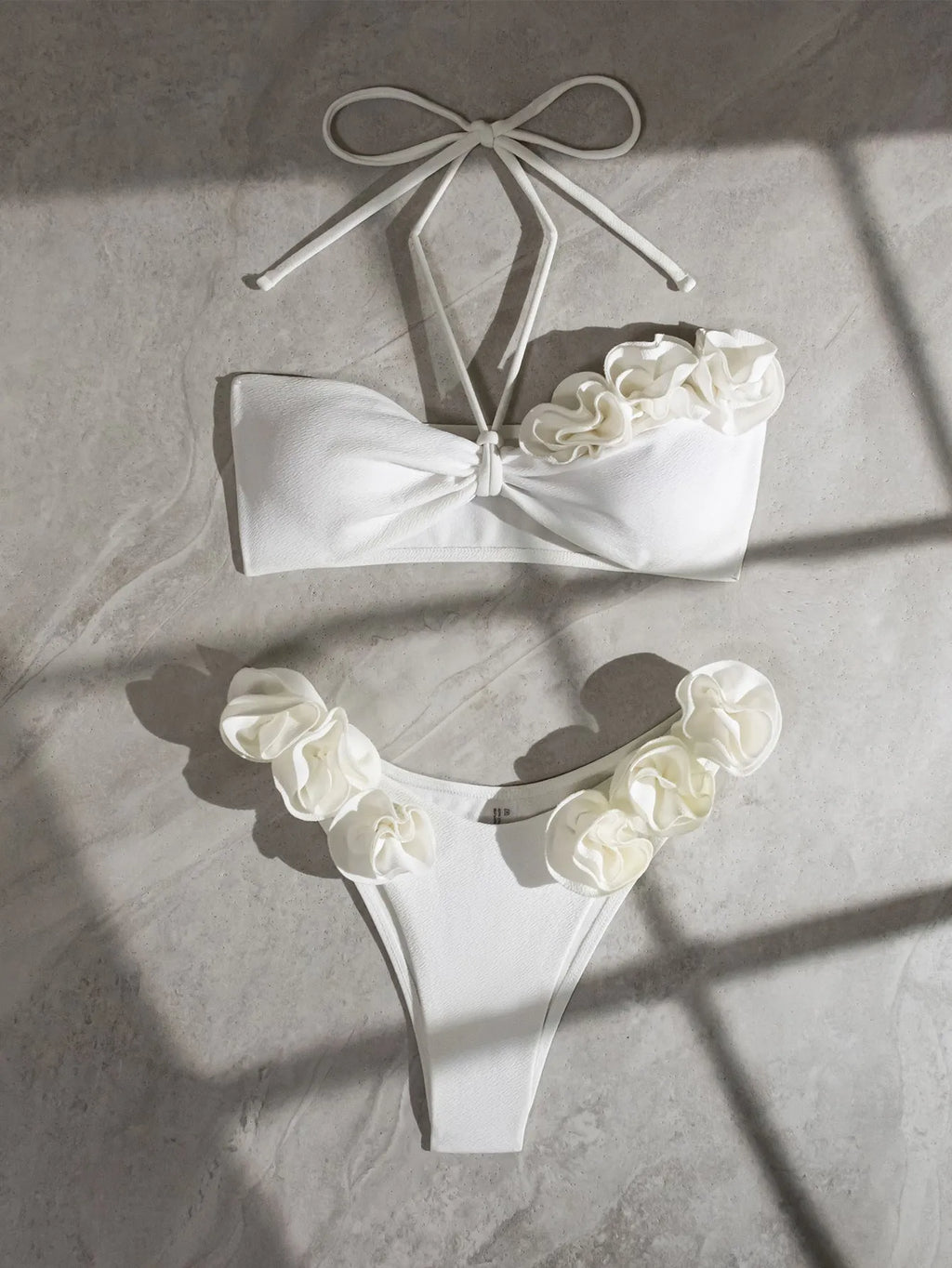 White halter neck lace-up swimsuit bikini with three-dimensional flower pattern.