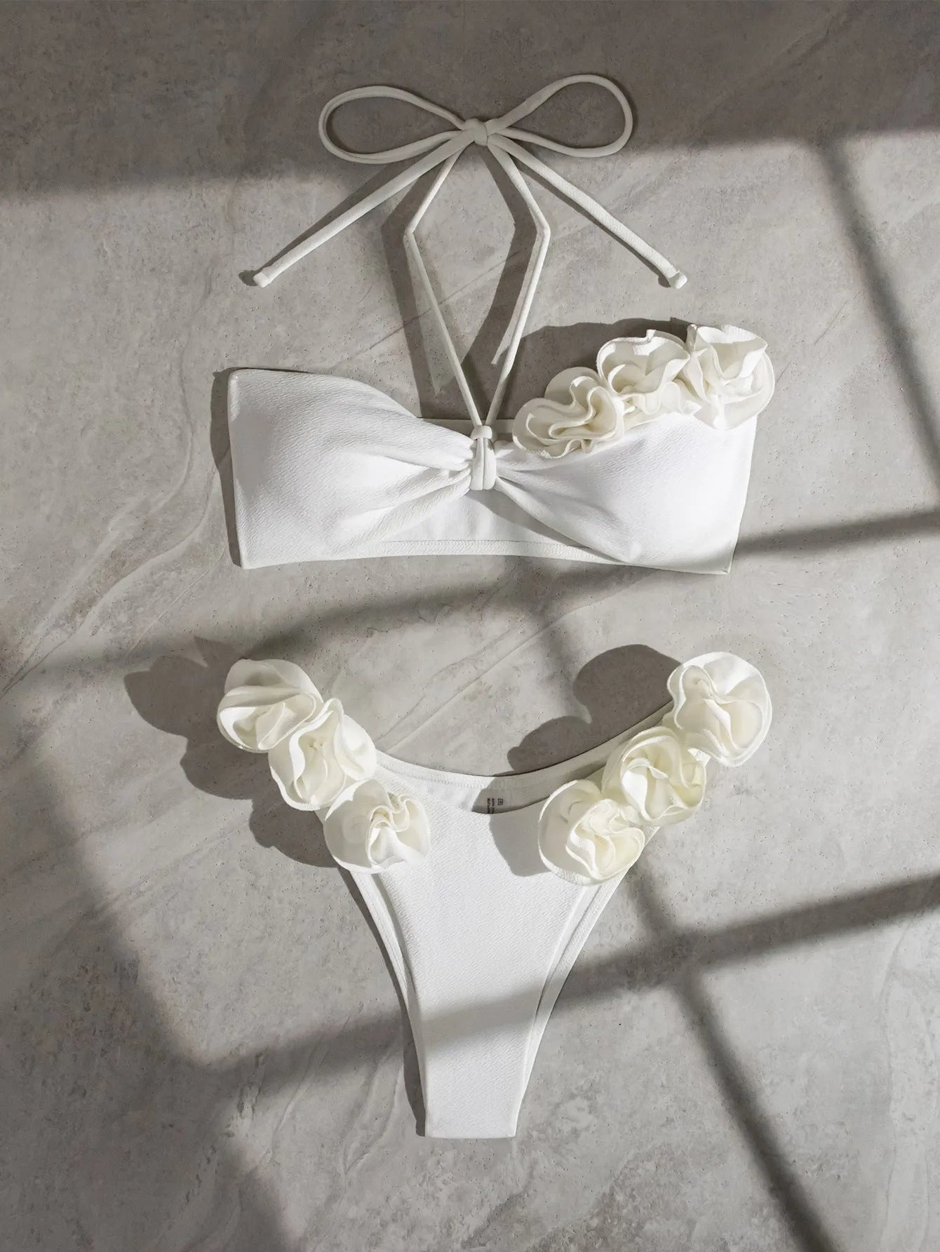 White halter neck lace-up swimsuit bikini with three-dimensional flower pattern.