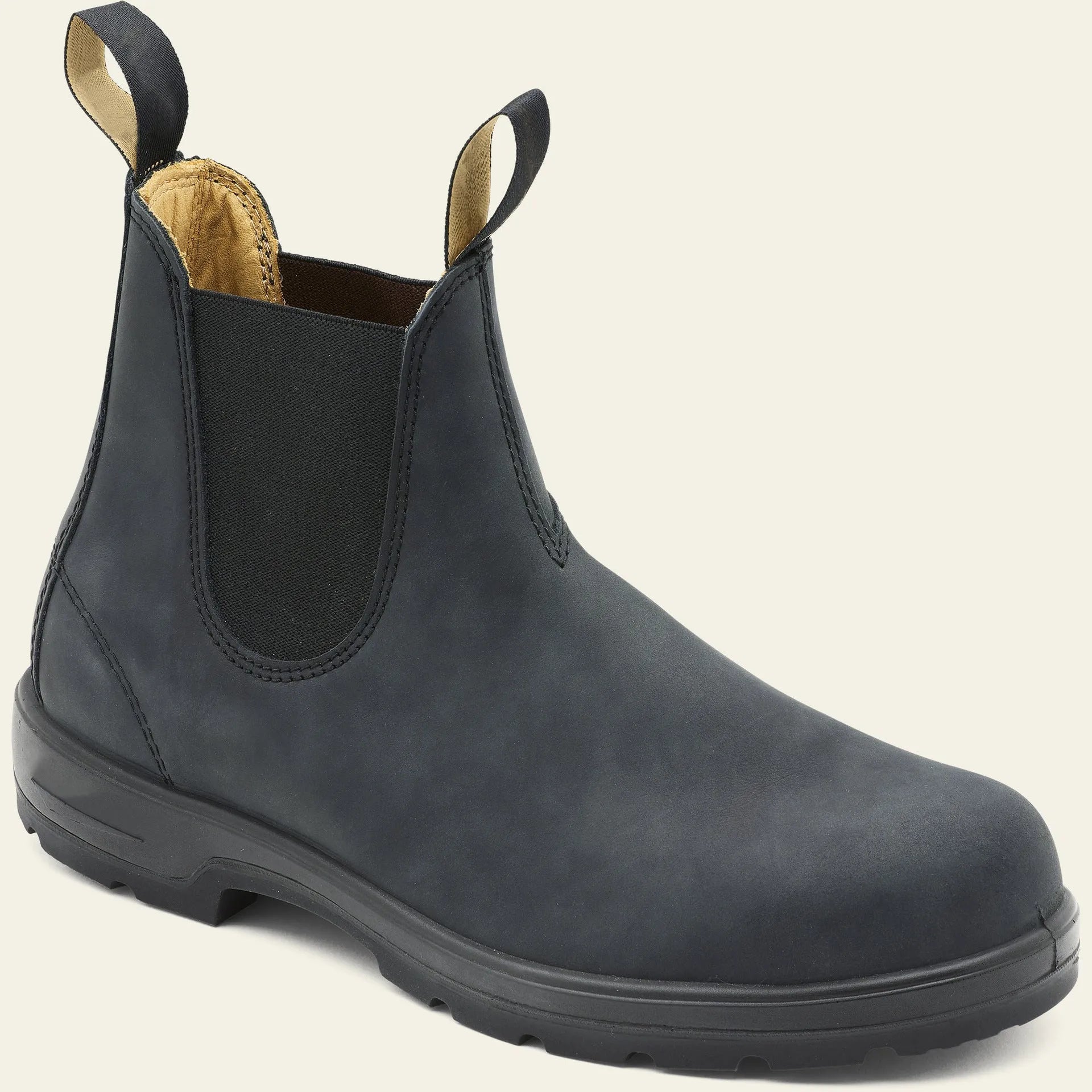 Vintage brown unisex Chelsea boot with round toe and beef tendon sole on a wooden floor.